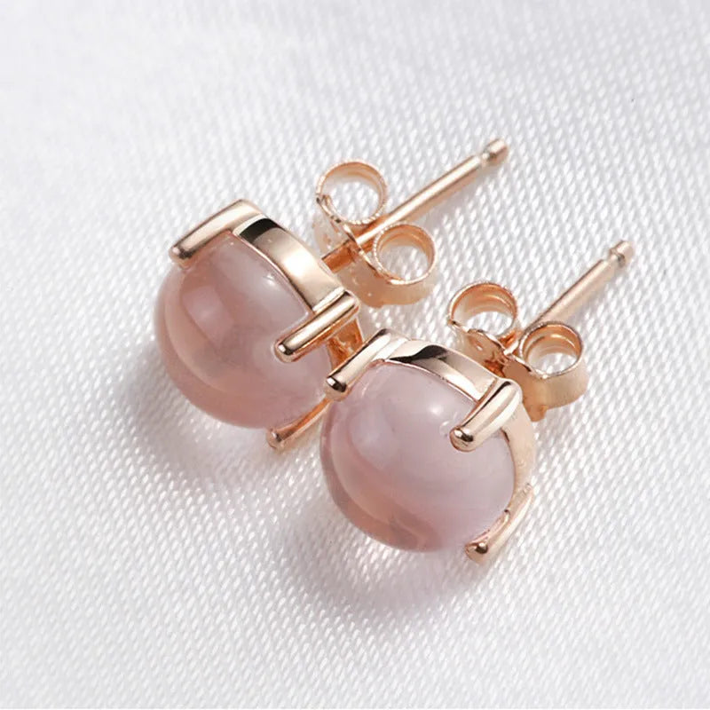 Rose gold plated copper stud earrings with synthetic ross quartz and crystal inlay in drop shape