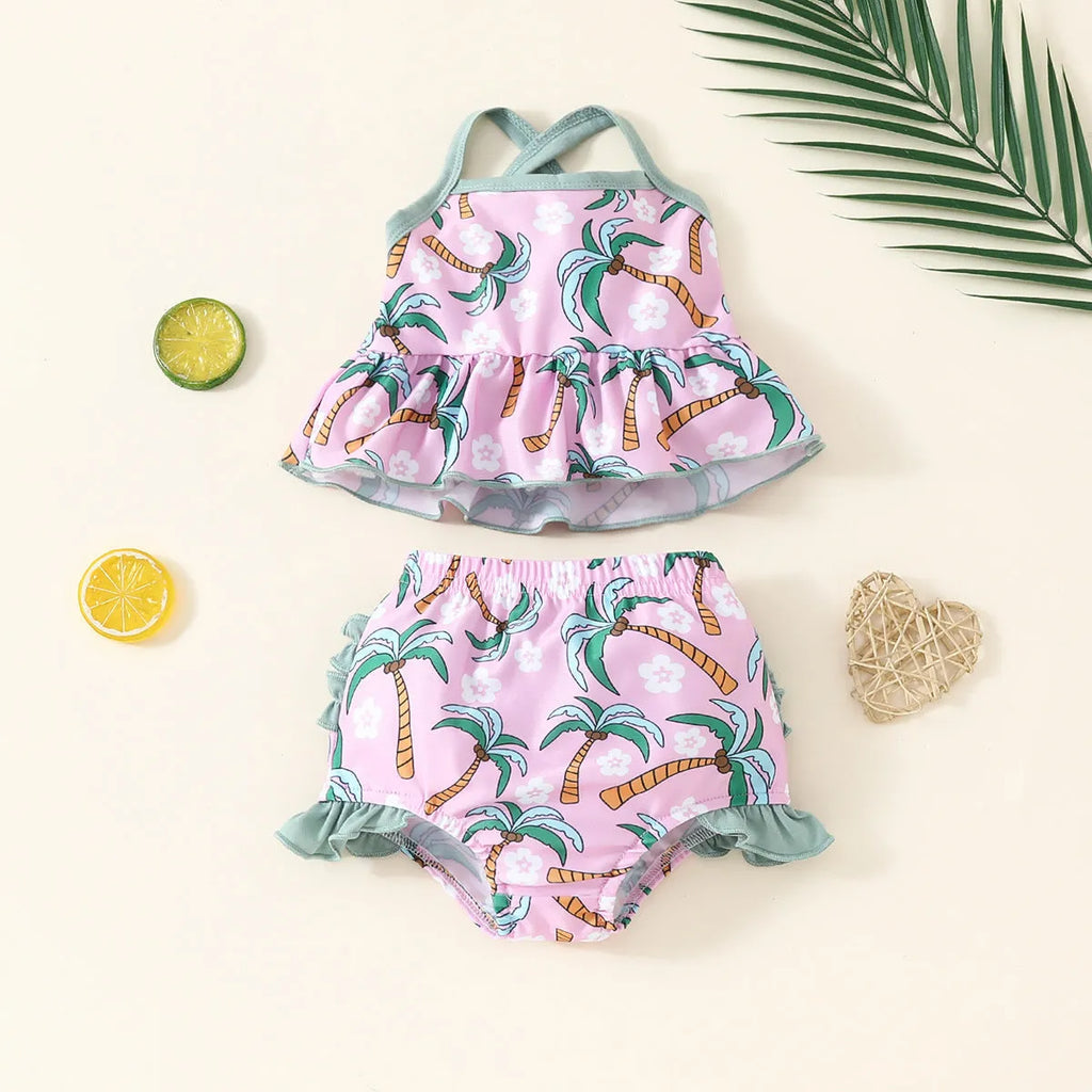 Girls' white two-piece swimsuit set with a shirt top and shorts on a hanger.