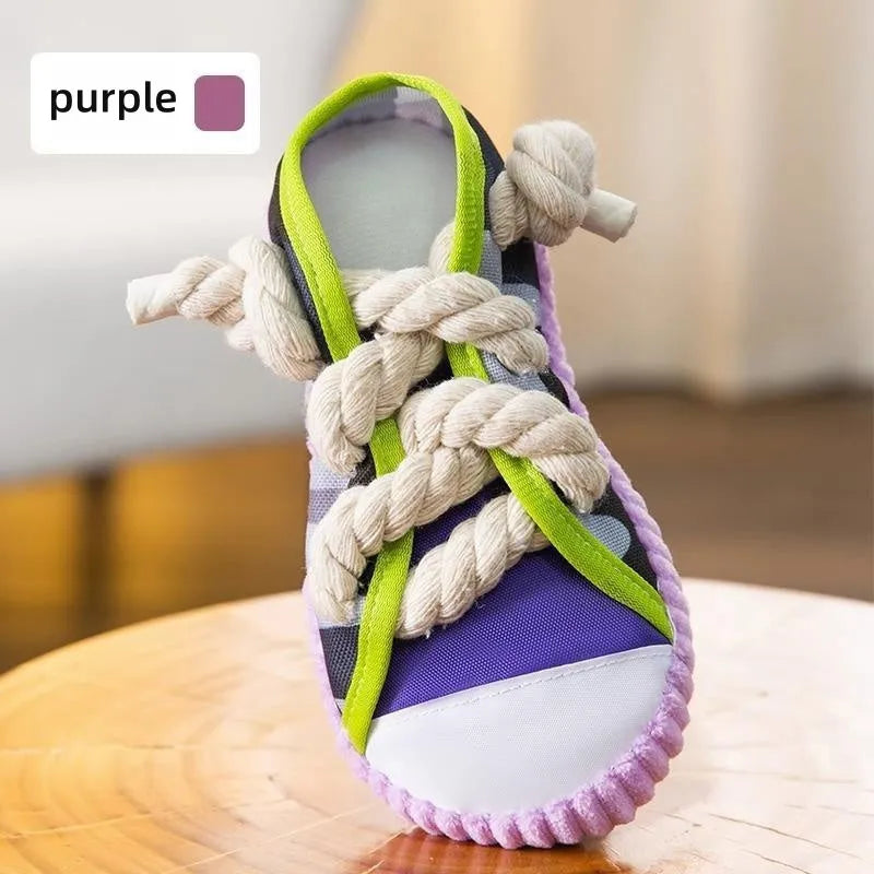 Realistic shoe-shaped dog toy in grey, purple, or yellow with laces, sole patterns, built-in squeaker and bell.