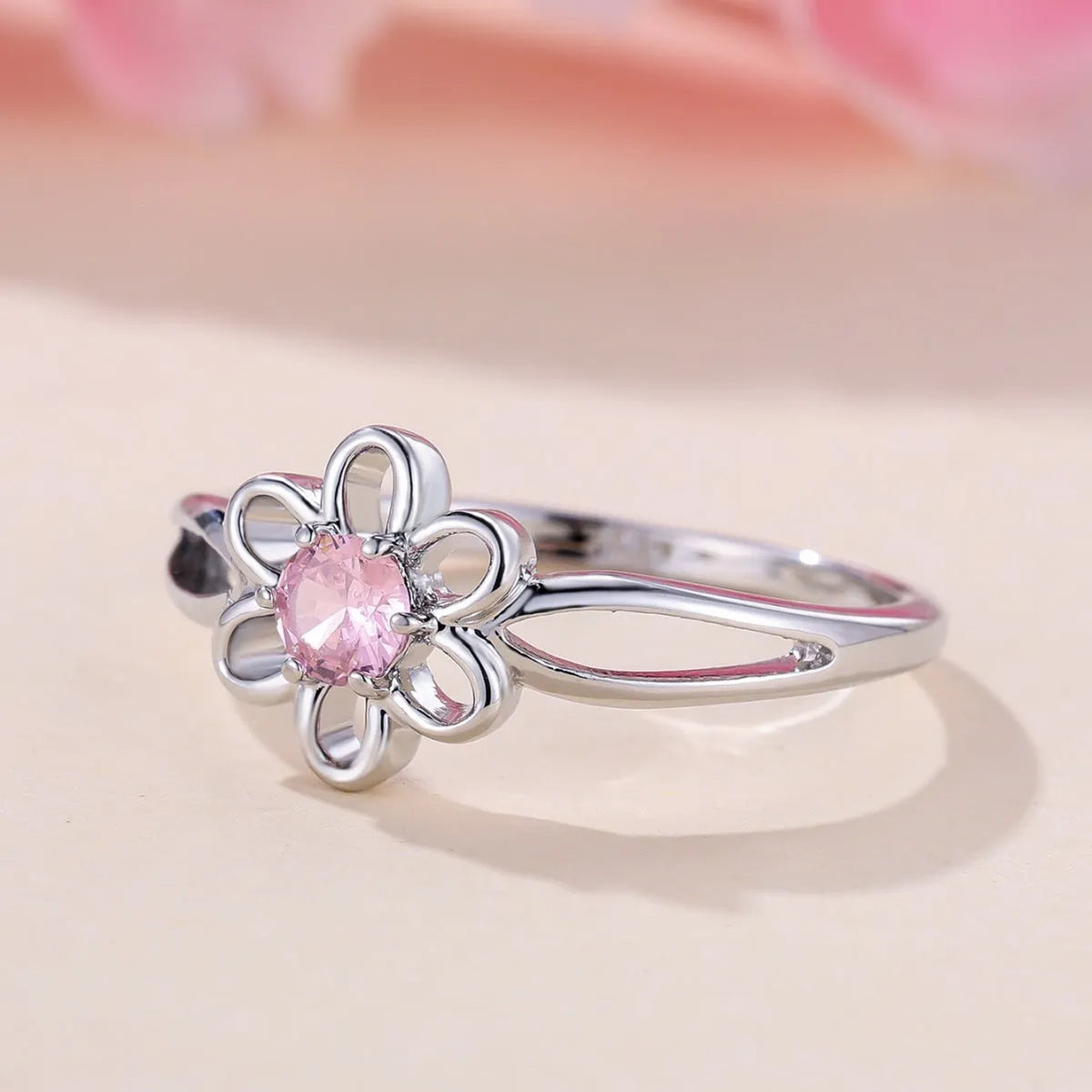 Women's flower hollow fashion ring in copper with electroplated metallic finish