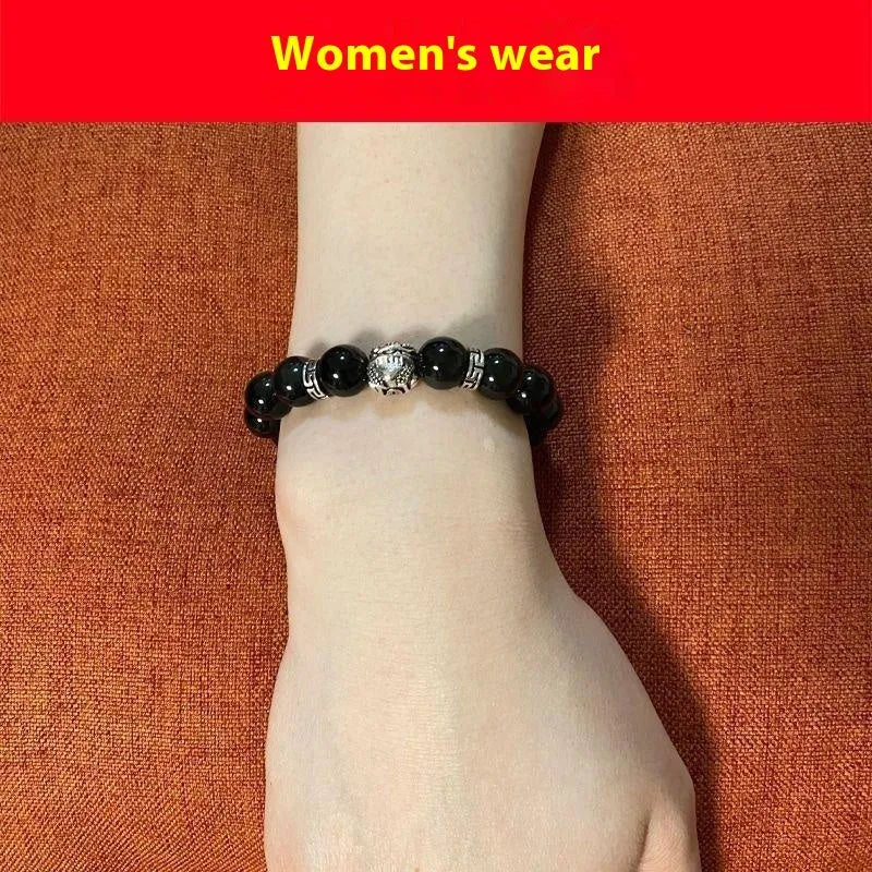 Natural obsidian bracelet with silver 999 clasp in 10mm or 12mm size on a wrist.