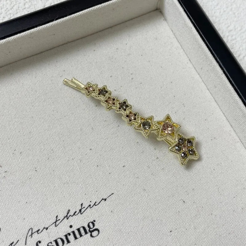 Gold electroplated rhinestone barrette with star design hair clip