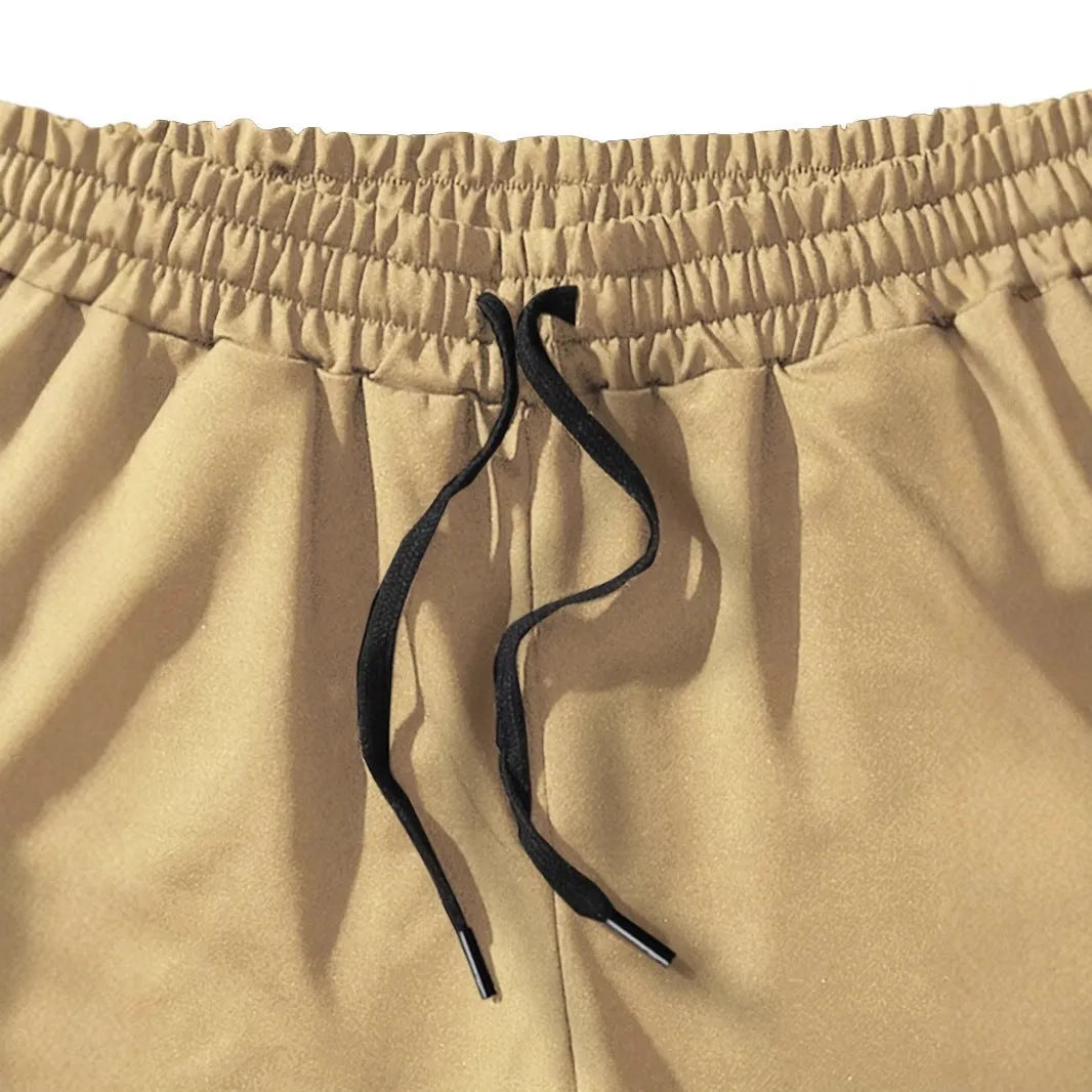 Men's khaki sports shorts with coconut leaf print pattern and straight leg design