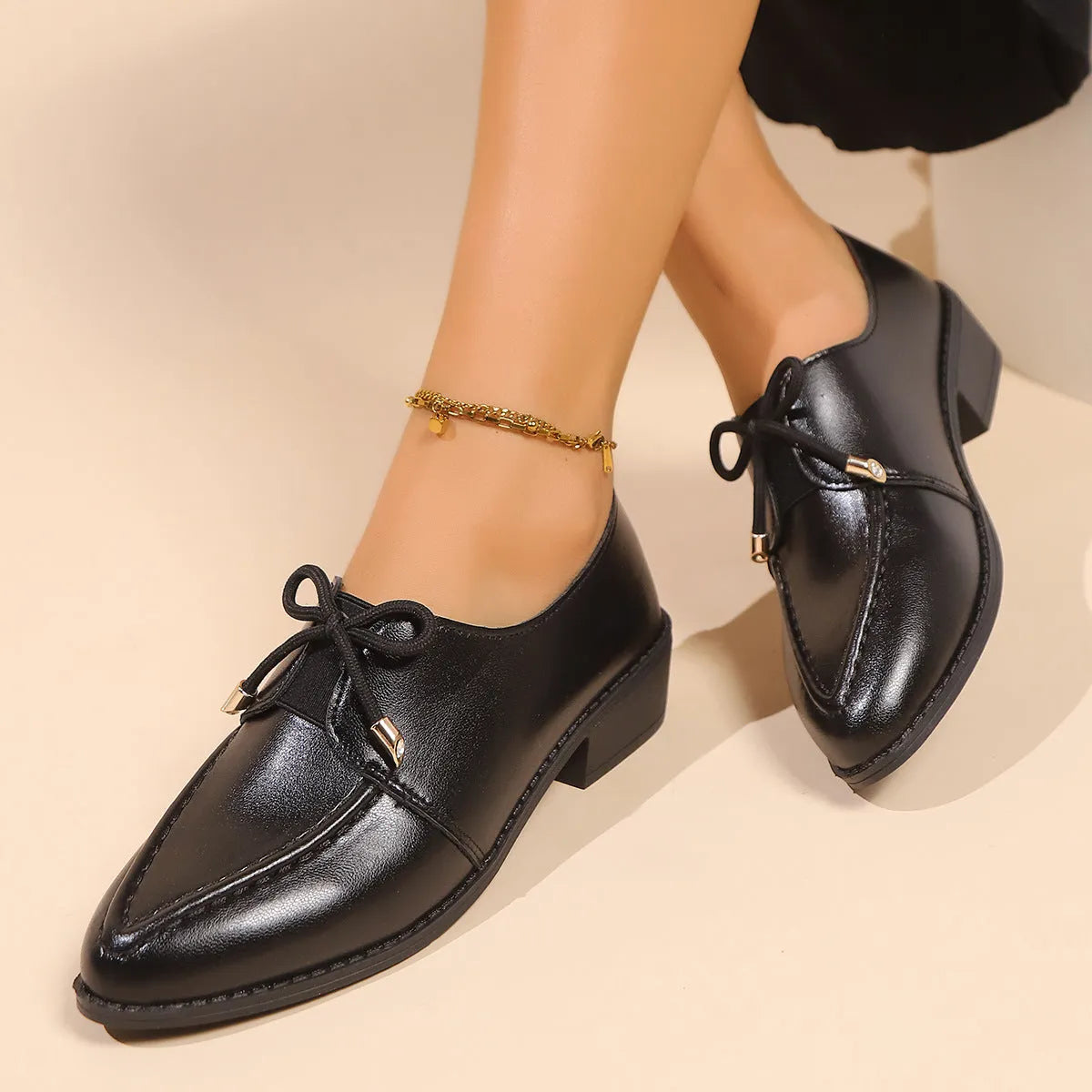 Women's simple leather shoes with bow decoration in British style, showing pointed toe and rubber sole