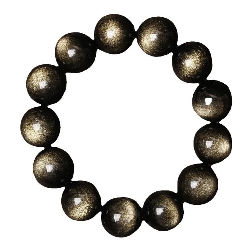 Hand-woven round obsidian bracelet in black stone, shown on a wrist.