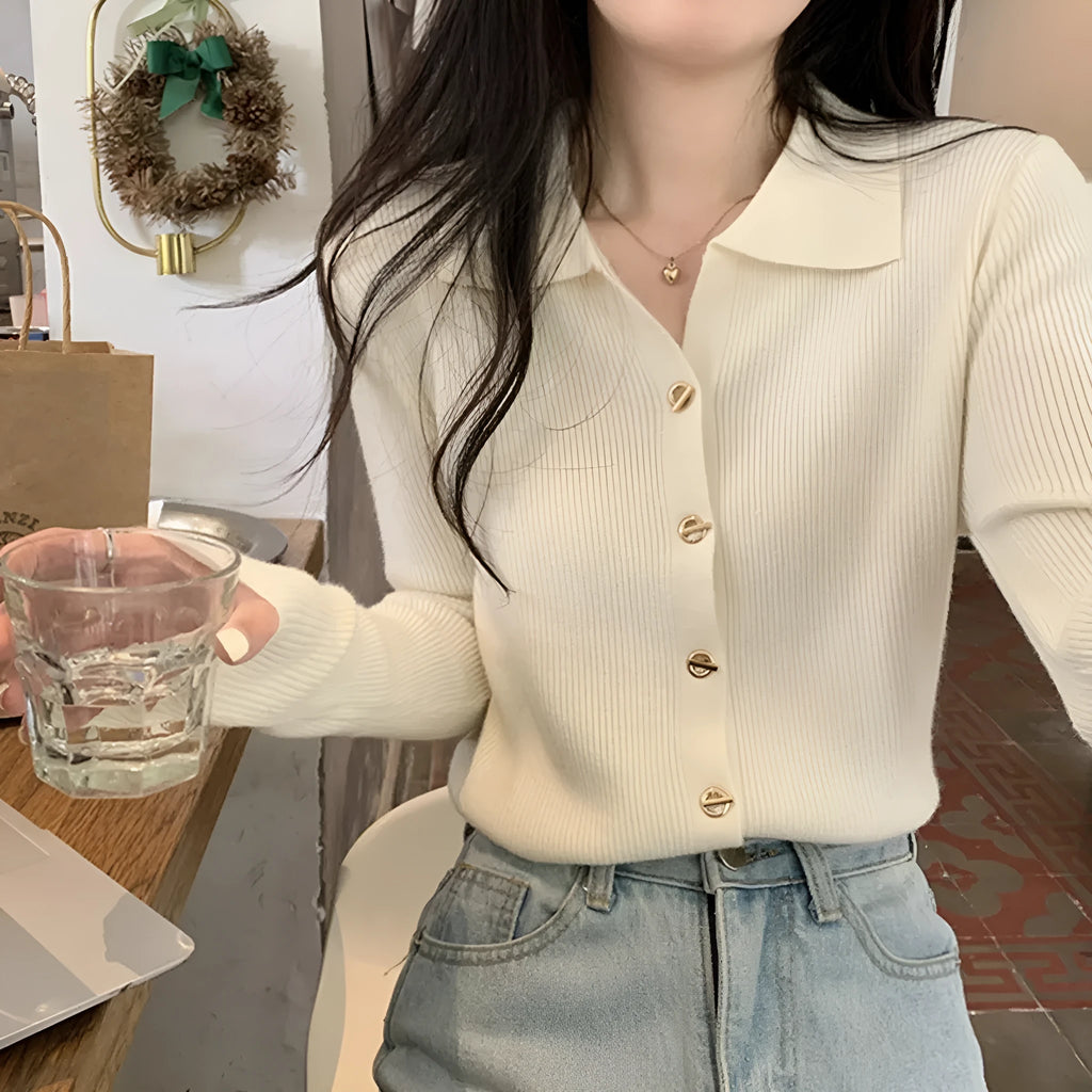Loose fit beige viscose knitted cardigan top with long sleeves on a hanger