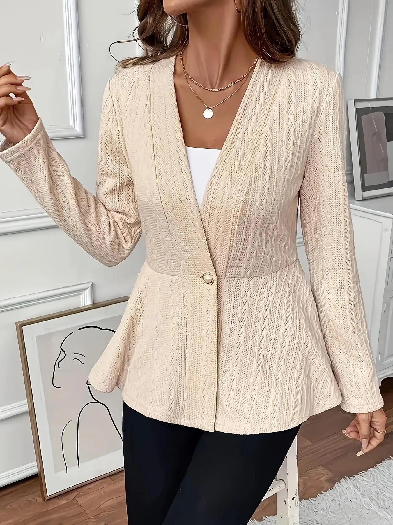 Women's apricot jacquard knit cardigan with one button front, shown on a model.
