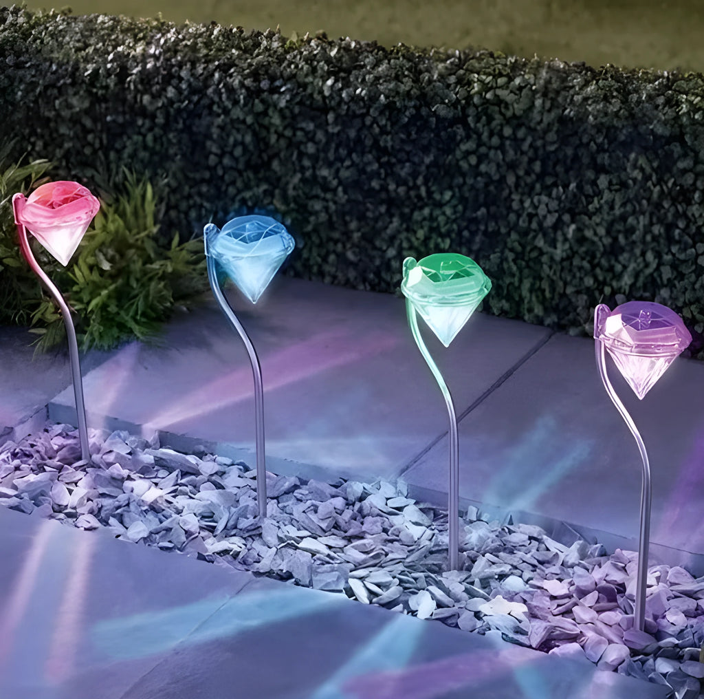 White solar-powered LED garden spotlight with adjustable head on a stake for outdoor use.