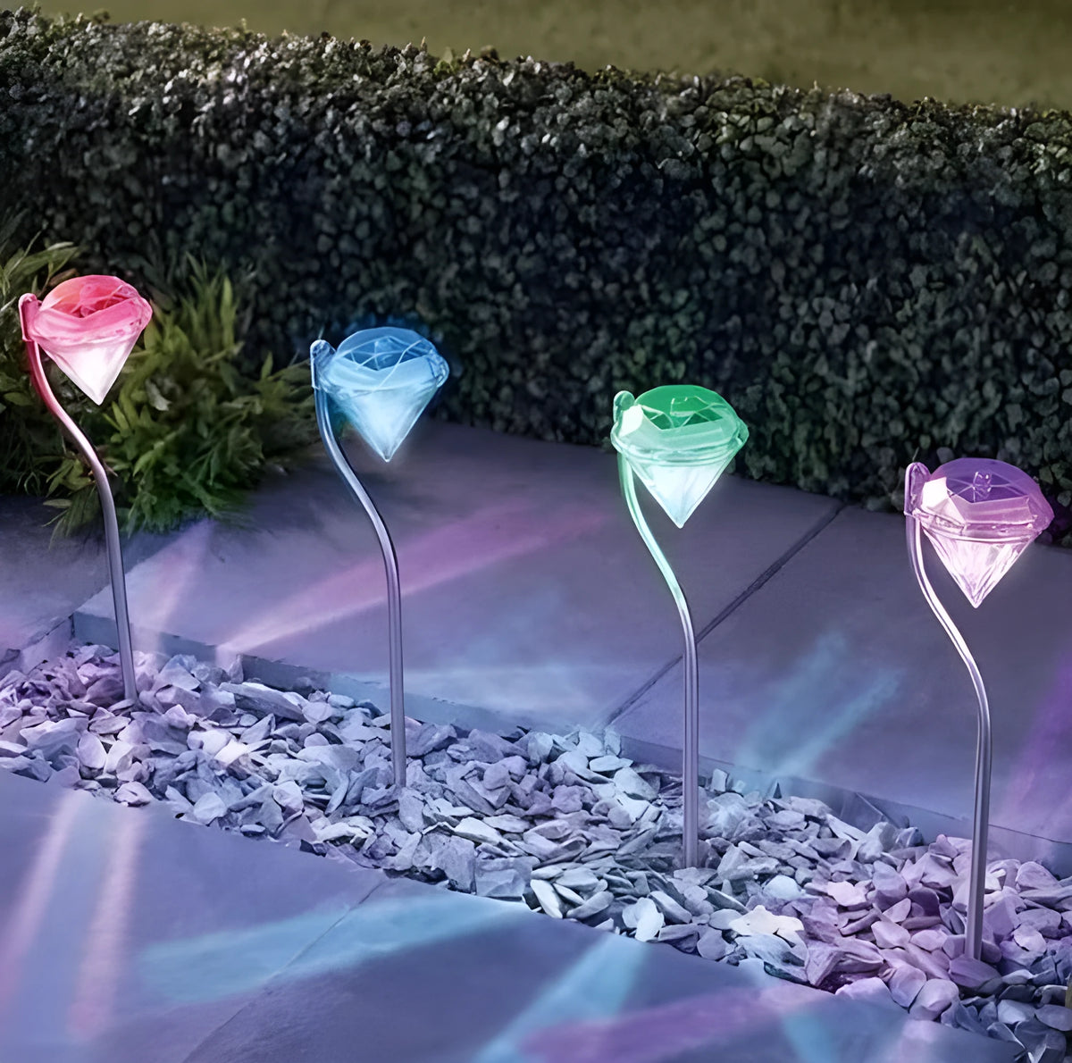 White solar-powered LED garden spotlight with adjustable head on a stake for outdoor use.