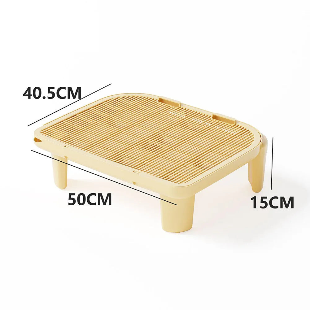 Milk yellow plastic cat litter mat with anti-slip feet next to a litter box
