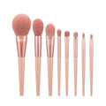 8-piece pink makeup brush set with man-made fibre heads and portable plastic handles, no bag included