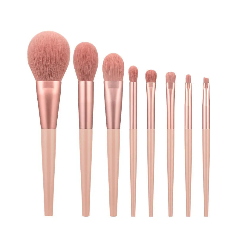 8-piece pink makeup brush set with man-made fibre heads and portable plastic handles, no bag included