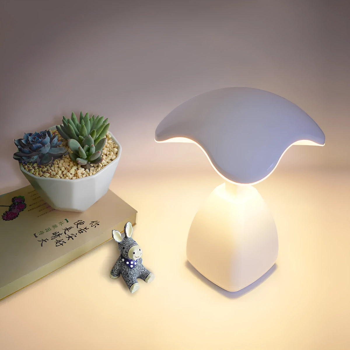 White modern LED desk lamp with a plastic shade and touch switch on a table.