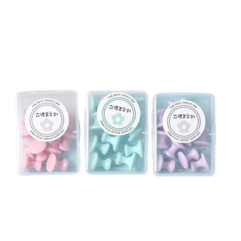 Plastic push pins in macaron colours: cherry blossom pink, mint green and lavender, displayed in small boxes.
