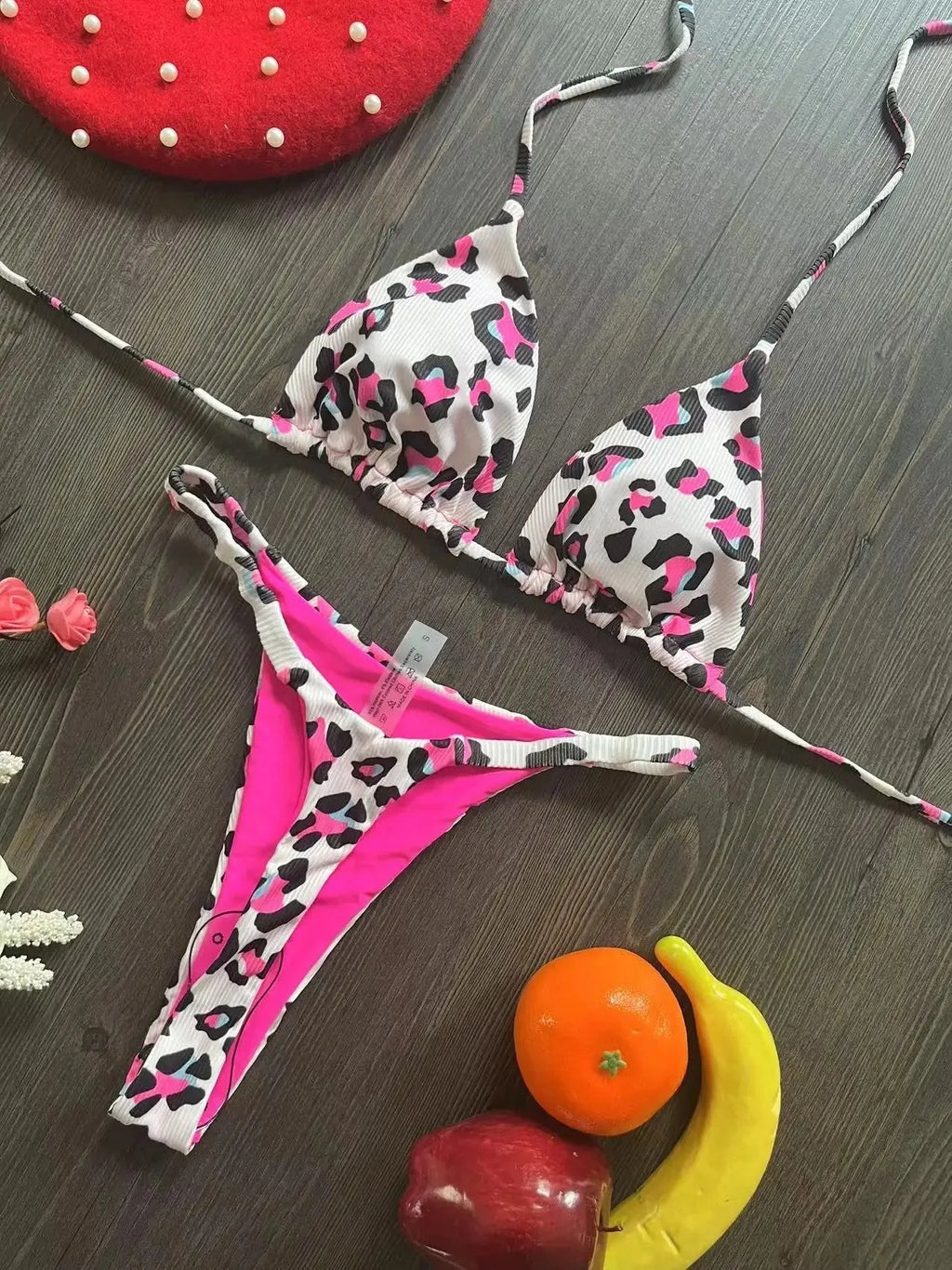 Women's printed bikini swimsuit set on a hanger, showing quick-dry fabric and cotton-lined briefs.
