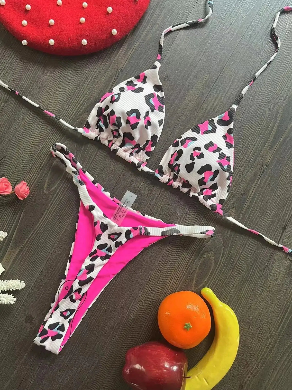 Women's printed bikini swimsuit set on a hanger, showing quick-dry fabric and cotton-lined briefs.