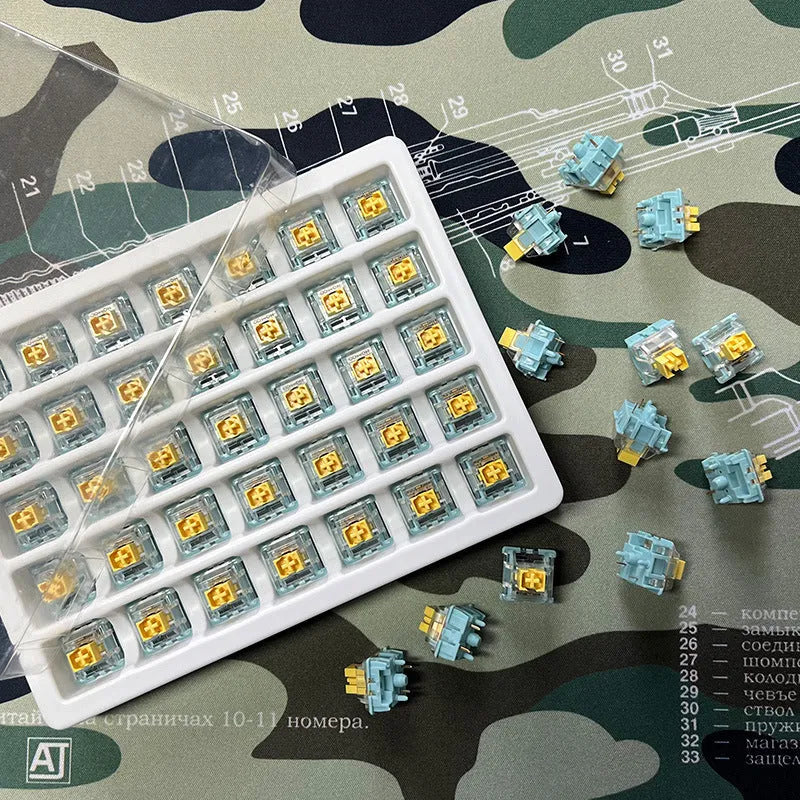 36 Sea Salt Lemon coloured PRO Mute mechanical keyboard switches laid out on a surface.