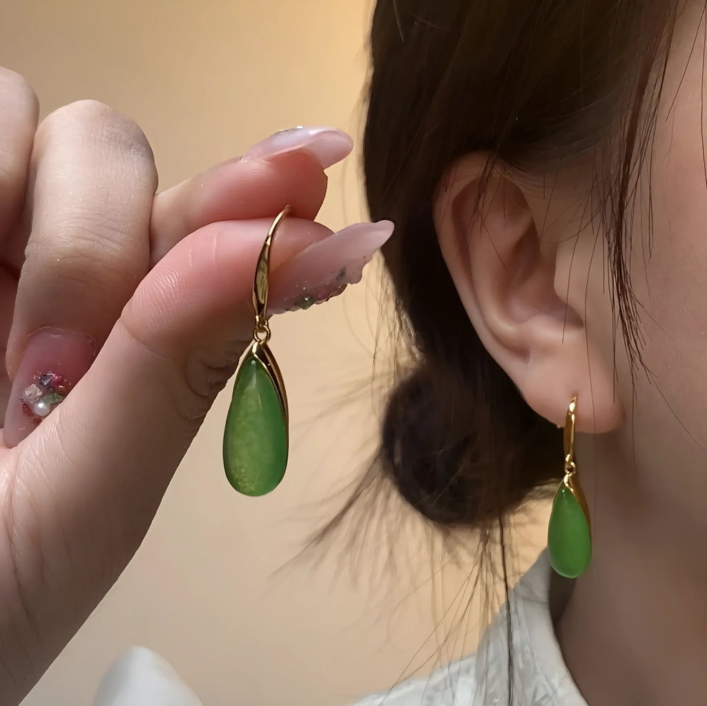 A pair of jade-coloured geometric copper earrings with a water drop element in a Chinese style.
