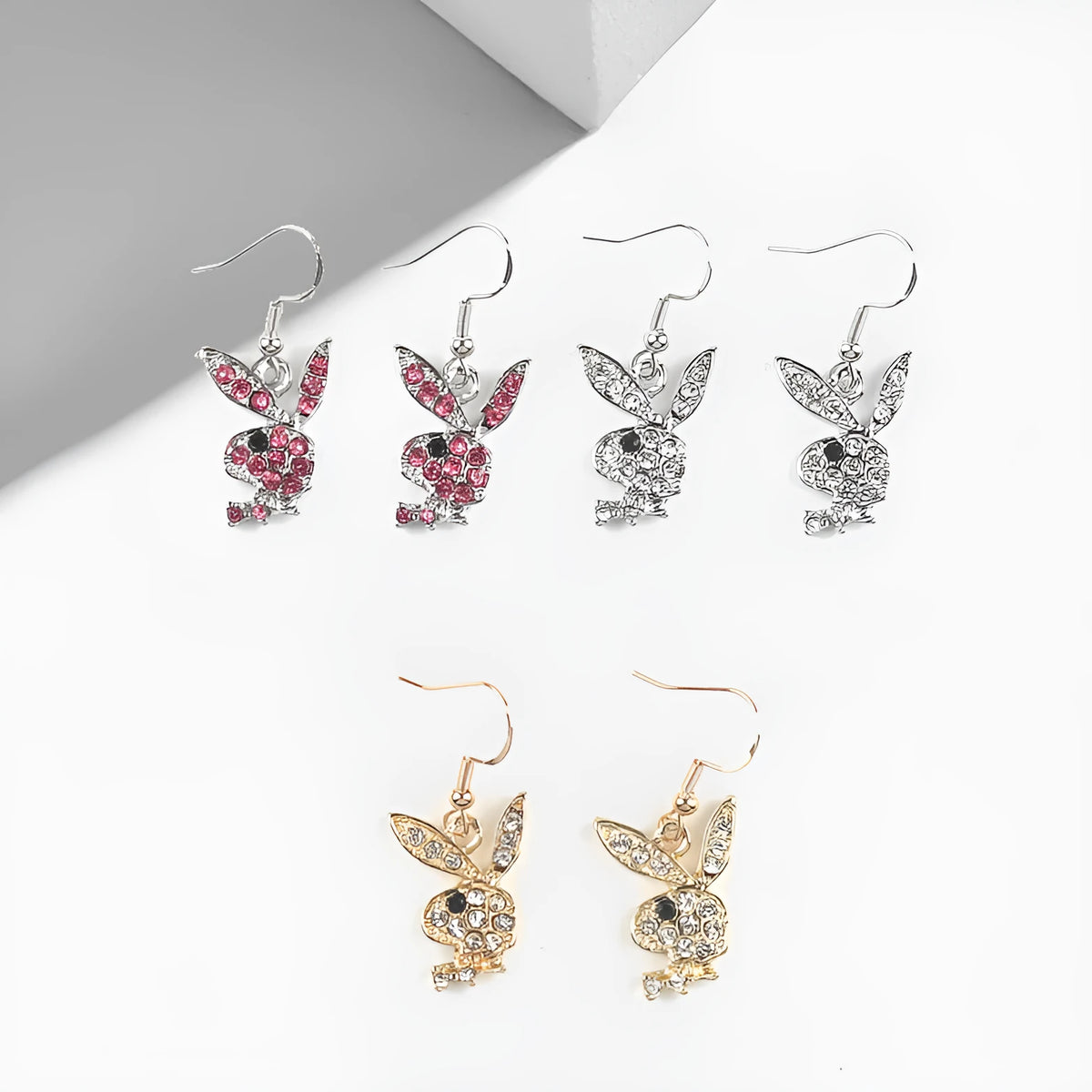 Cute cartoon rabbit stud earrings in silver, pink, or gold colour on alloy posts.