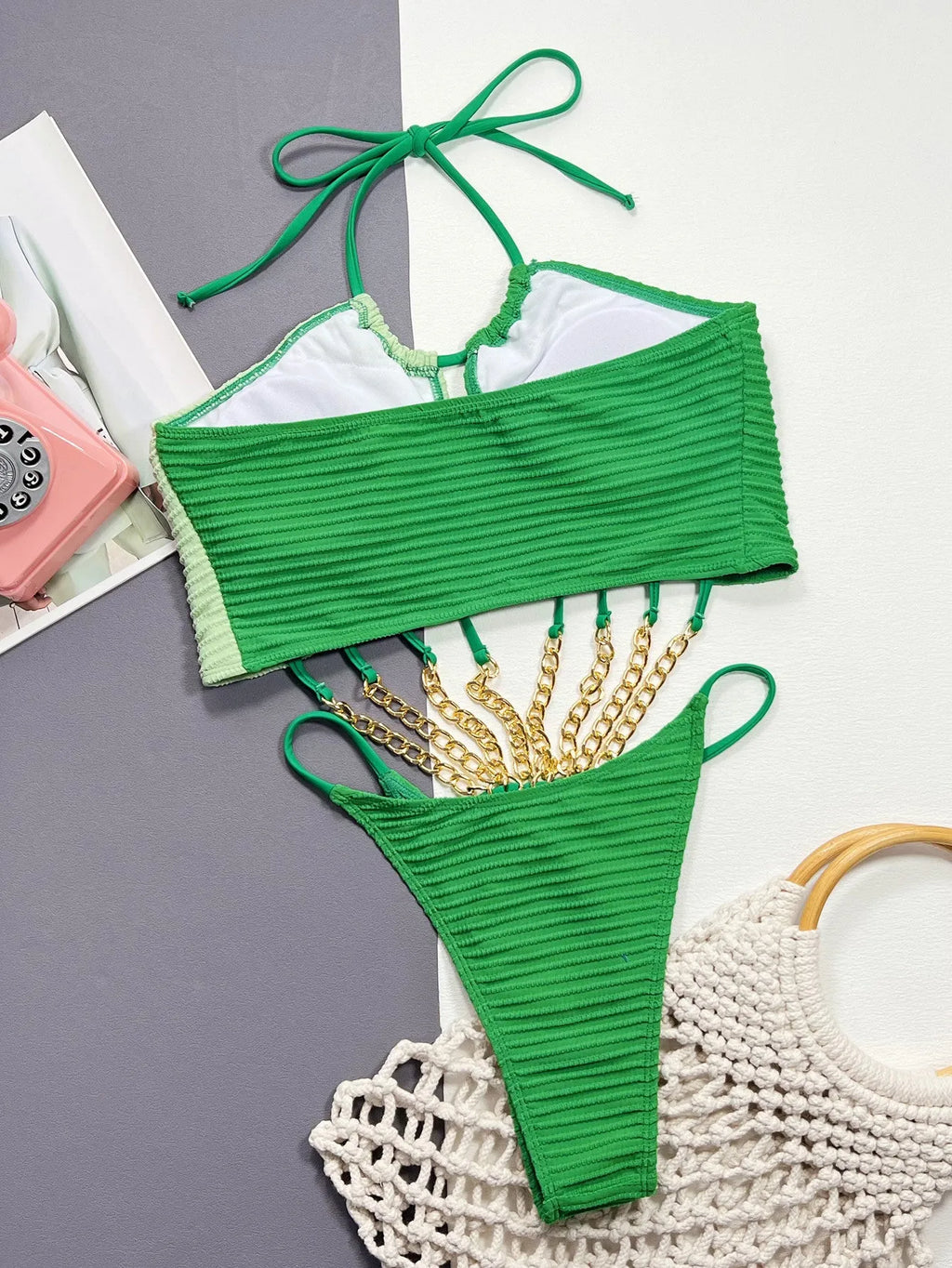 Solid green women's one-piece swimsuit with a hollow design on a mannequin.