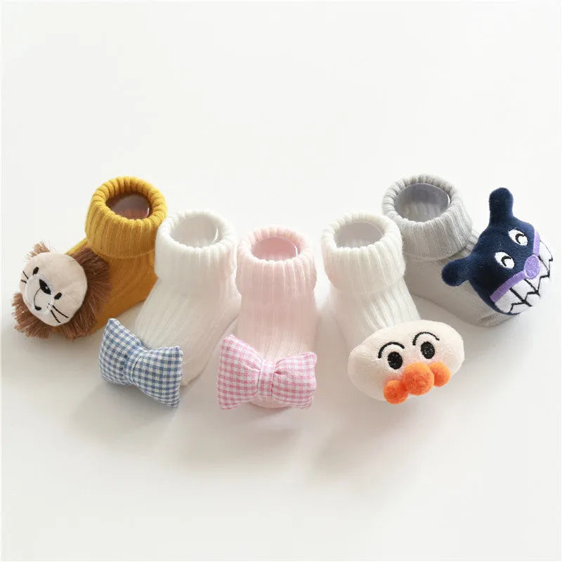 Cotton baby floor socks in a selection of colours and patterns like panda, lion, and bows, shown in sizes for infants.
