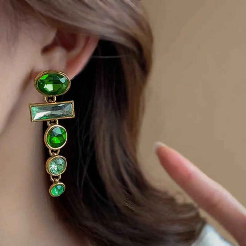 Green gradient geometric alloy earrings with dangling tassels and inlaid zircon stones.
