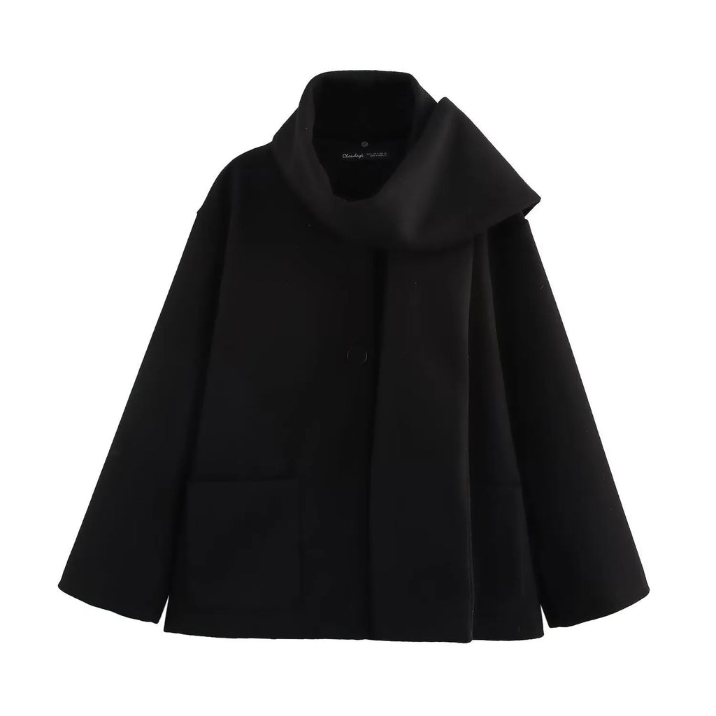 Women's long black polyester overcoat with artificial fur collar and pockets, showing extended length.