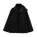 Women's long black polyester overcoat with artificial fur collar and pockets, showing extended length.