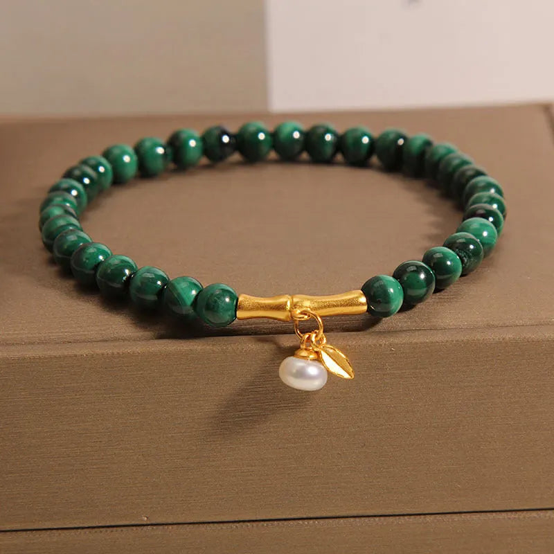 Women's adjustable bamboo bracelet with white crystal elements on a wrist.