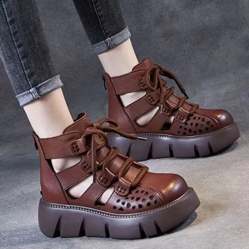 Women's black platform sandals with hollow hole design and fish mouth toe, made from soft leather.