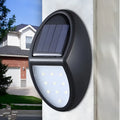 Black rectangular solar-powered LED wall light with solar panel on top.