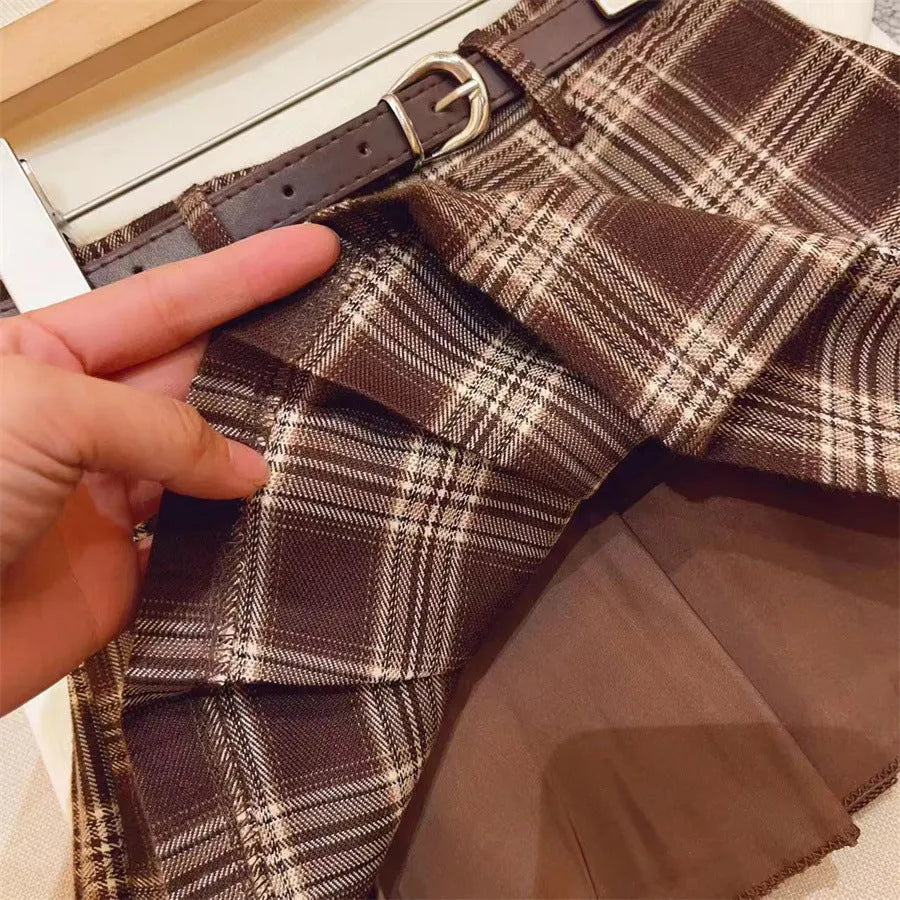 Girls plaid pleated A-line skirt in cotton-blend fabric, shown on a hanger.