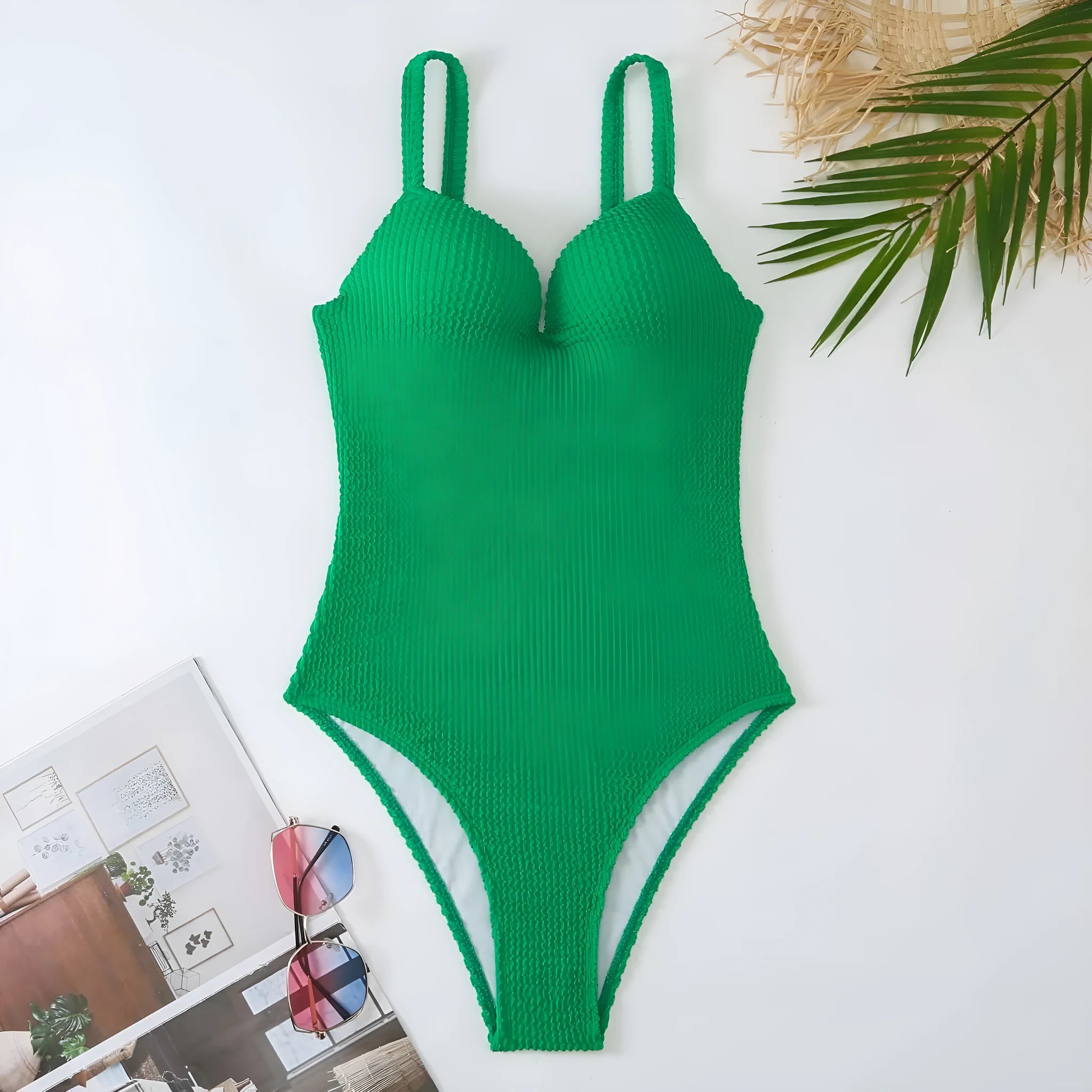Women's black one-piece swimsuit with a sunken stripe pattern, shown on a mannequin.