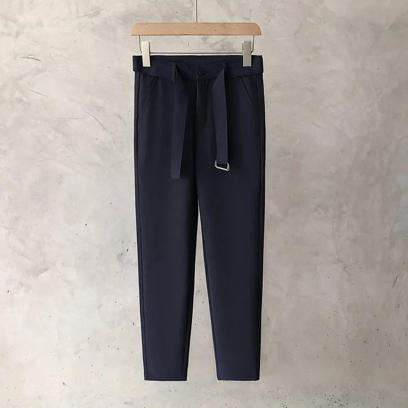 Boys slim straight trousers in wool blend fabric on a hanger, showing tapered leg