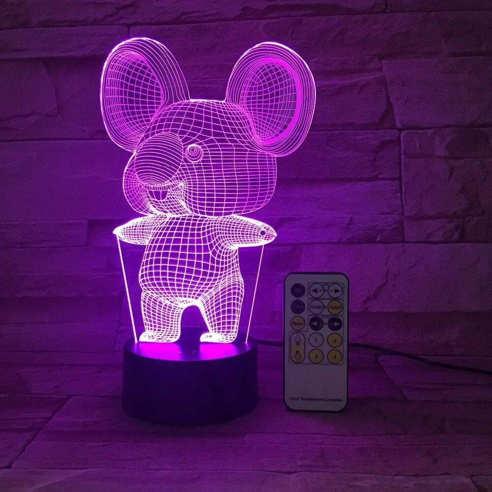Koala-shaped LED night light with remote control on a bedside table, showing multiple colour options.