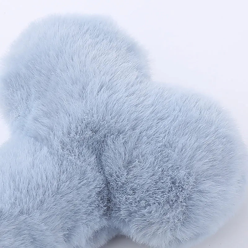 Soft plush dog toy shaped like a bone with a love heart design, in blue colour with a squeaker.