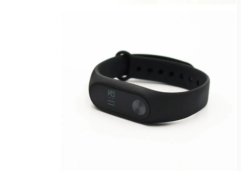 Black Xiaomi Mi Band 2 fitness tracker on wrist showing OLED screen with heart rate data.