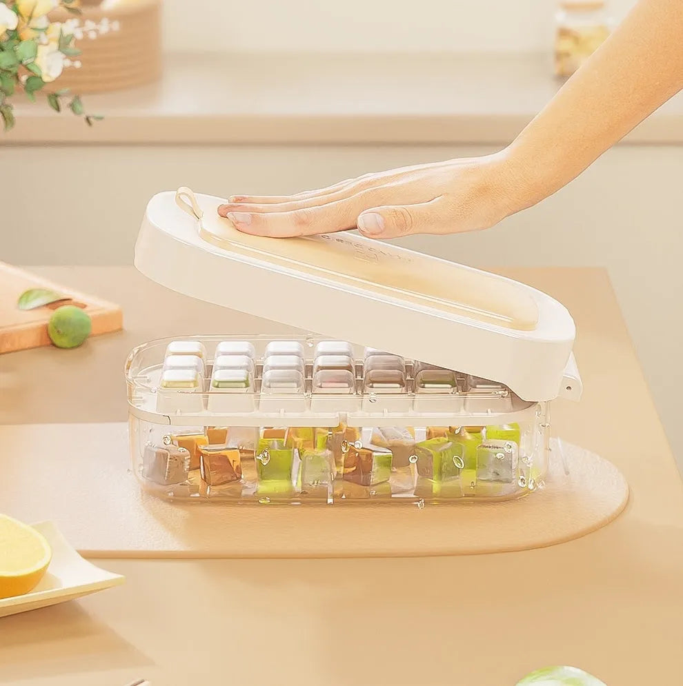 Colourful lever-action ice cube tray grid with integrated storage for its ice shovel.