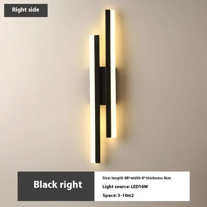 Scandinavian minimalist LED wall light with an acrylic shade on a black arm, mounted on a light-coloured wall.