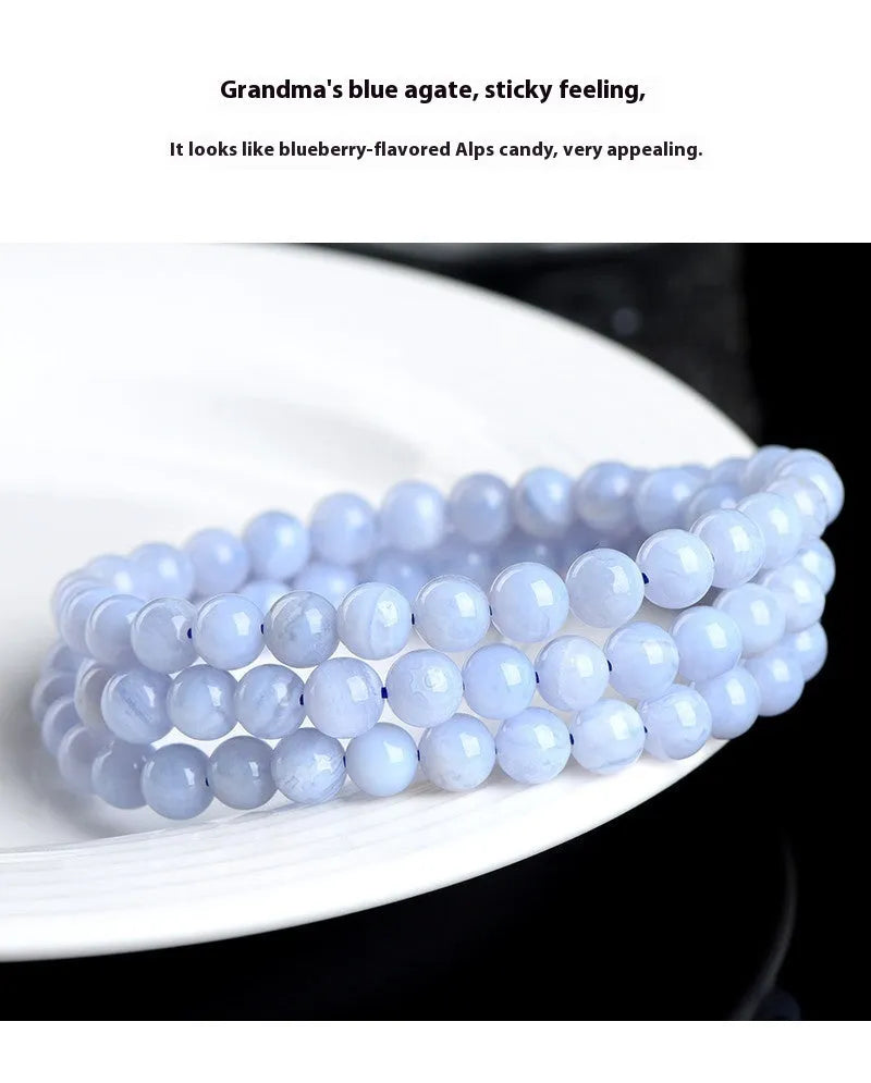 Blue agate beaded bracelet with multi-circle patterns and Ruyi design elements on a wrist.