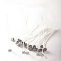 Close-up of white cotton candle wicks in three lengths: 2.6cm, 6cm, and 8cm.