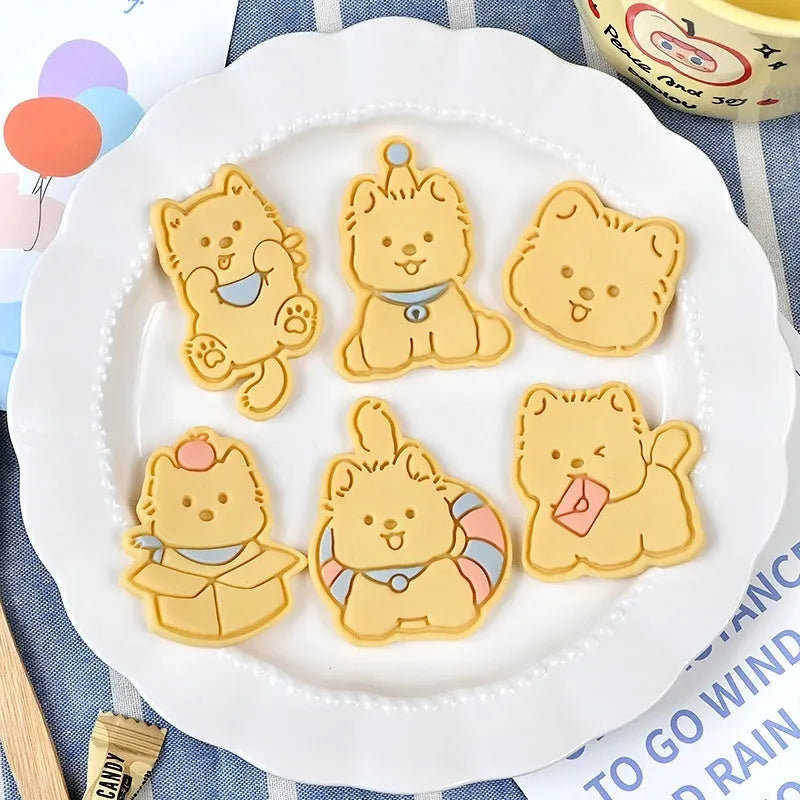 Three dimensional press plastic biscuit mould showing cartoon puppy designs
