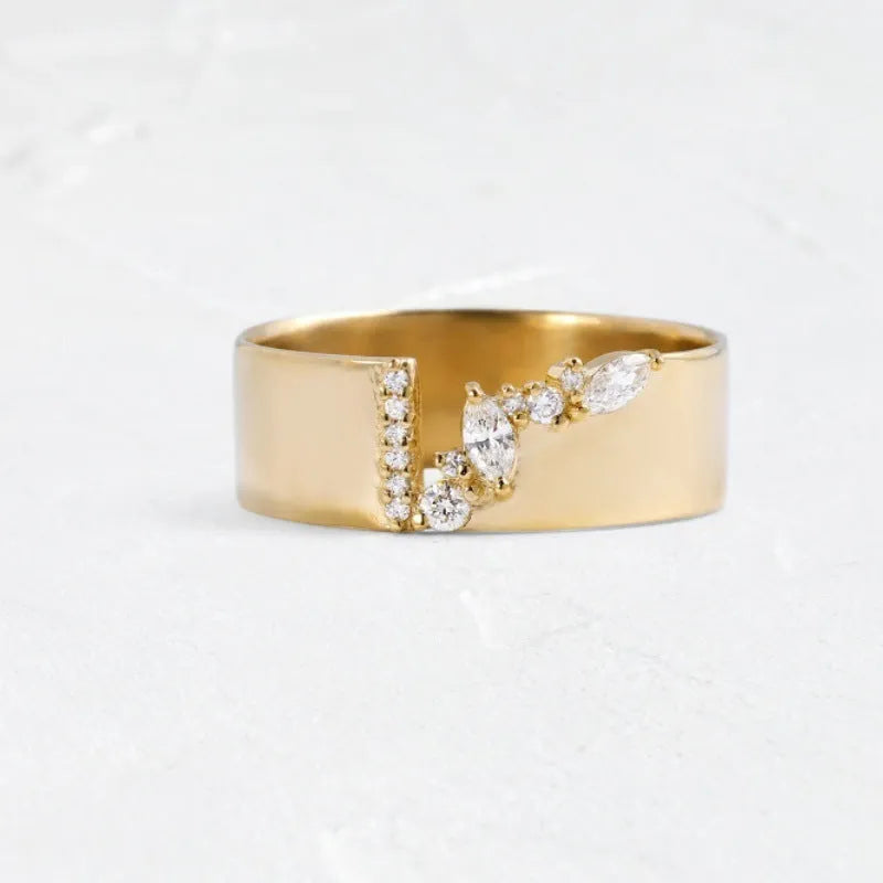 Gold electroplated zircon ring on finger, showing metallic finish and decorative elements