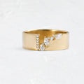 Gold electroplated zircon ring on finger, showing metallic finish and decorative elements