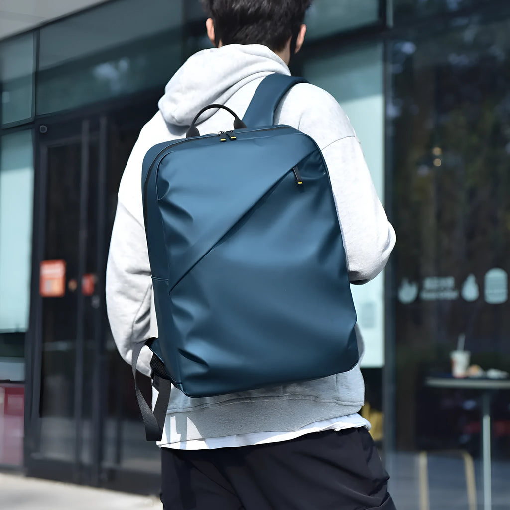 Large waterproof backpack in PU leather available in black, blue, or grey colours