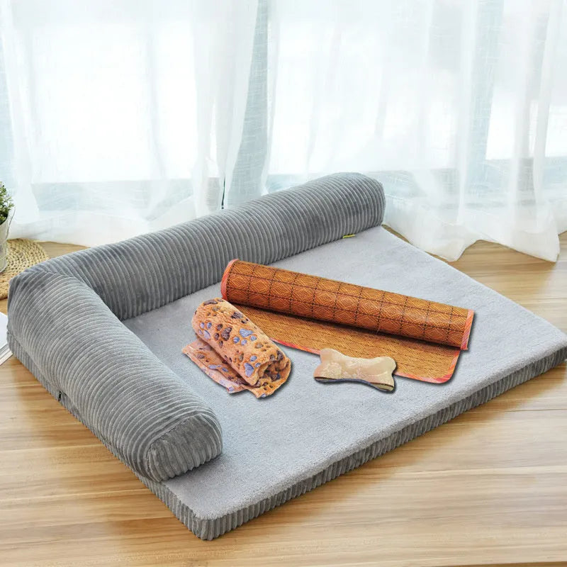 Grey corduroy dog sofa bed with bilateral bolsters on a wooden floor.