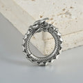 Close-up of large geometric dragon silhouette hollow out alloy earrings in antique silver finish.