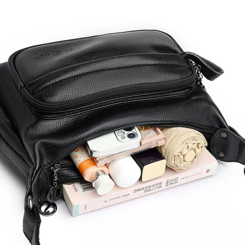 Large black or blue PU crossbody bag with organised internal compartments and soft handle