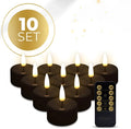 Four black S10 LED flameless tealight candles on a table.