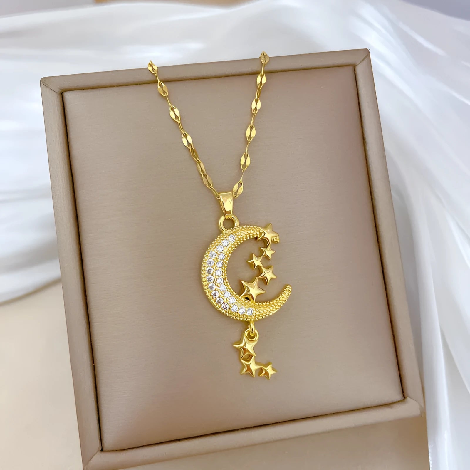 Geometric moon pendant necklace with diamond accents on stainless steel chain, copper pendant with tassel styling
